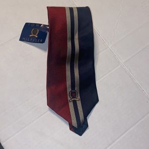 New with tag Tommy Hilfiger navy blue, red, and gold neck tie.